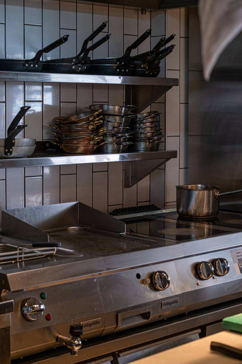 Commercial cooking range and griddle in a stainless-steel kitchen